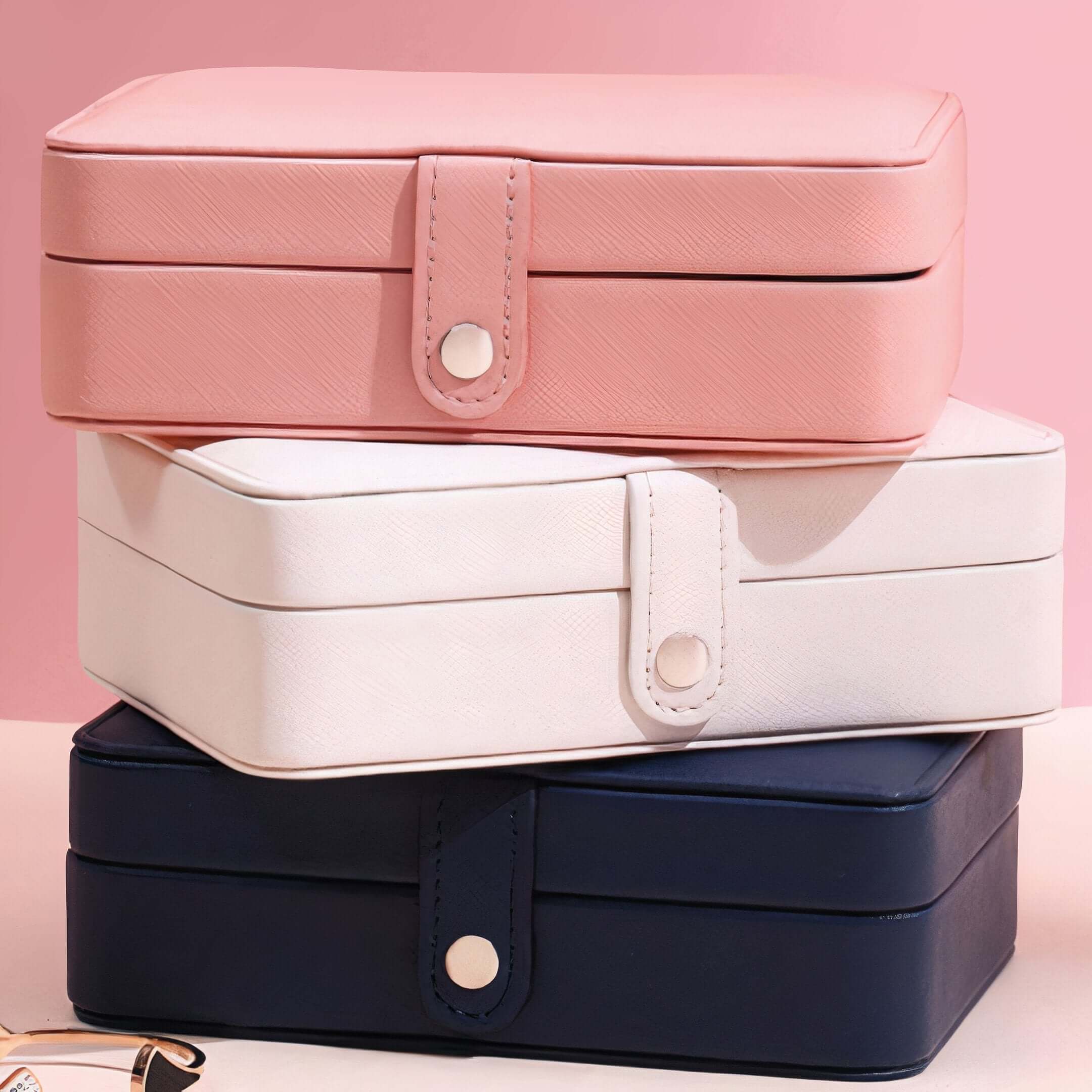 Smart Jewelry Box in pink, white, and navy, perfect for organizing and traveling with your jewelry.