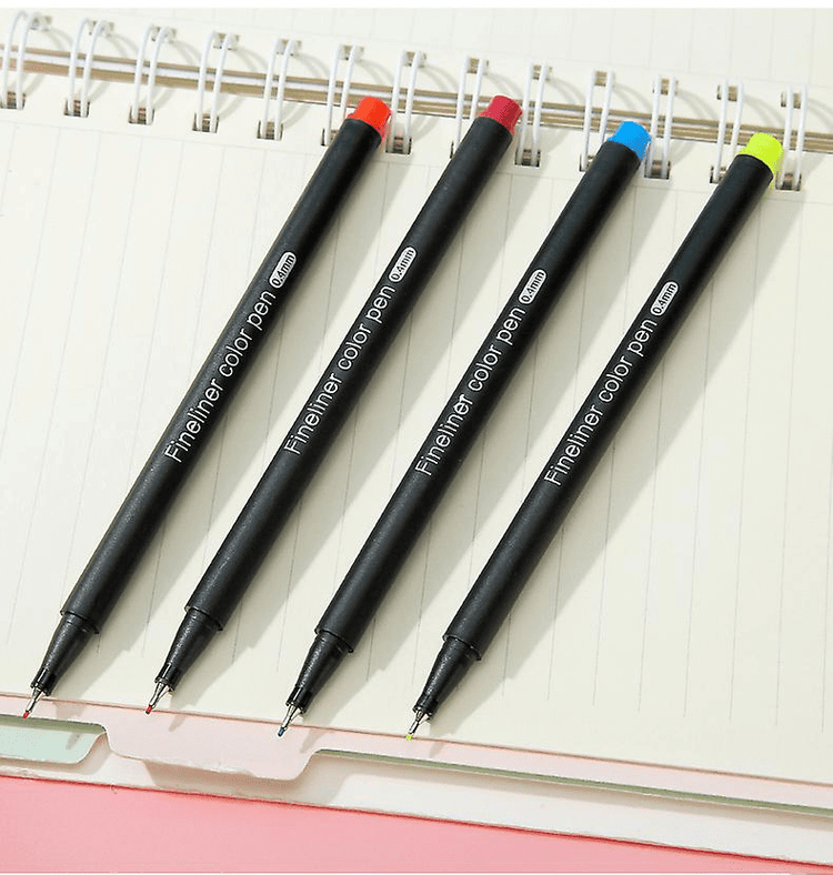 Fine Point Markers in various colors on a notebook, perfect for art drawing and detailed illustrations.