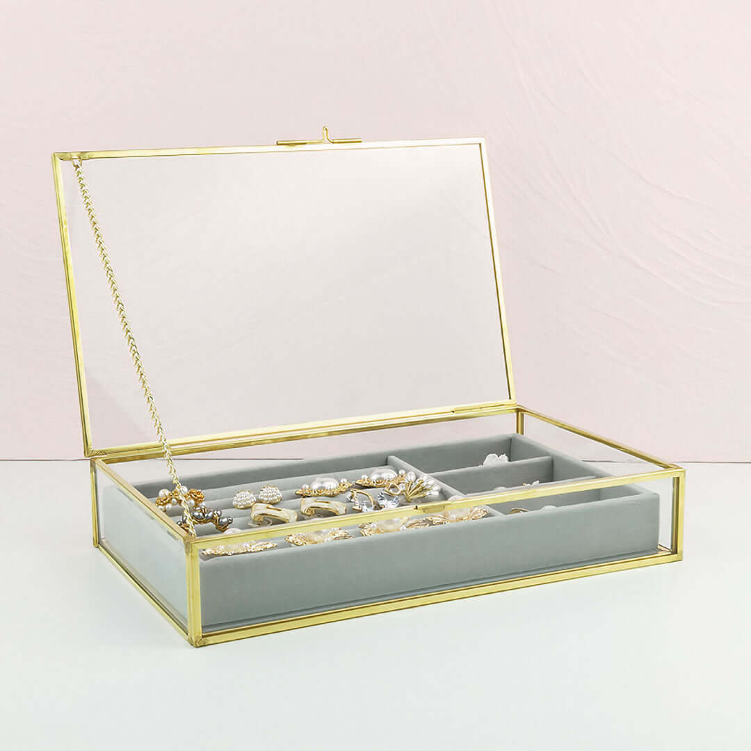 Organizing Jewelry Box with compartments and glass top for stylish jewelry storage.