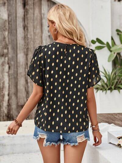 Back view of the Amy Petal Sleeve Top showcasing its unique print and petal sleeves.