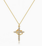 Gold cross necklace with diamond accents on a white background