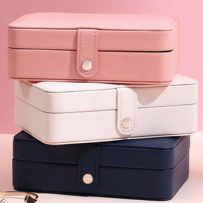 Smart Jewelry Box in pink, white, and navy, perfect for organizing and traveling with your jewelry.