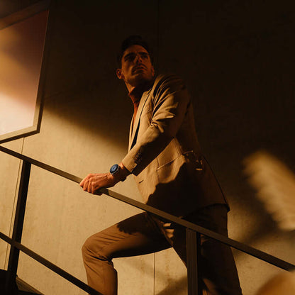 A man wearing the Amazfit GTR3 Pro Smartwatch with GPS and Health Monitor while posing on a staircase in a modern setting.