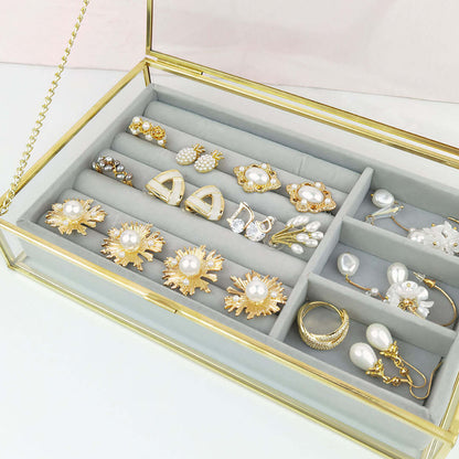 Organizing Jewelry Box with compartments showcasing various elegant earrings and accessories.