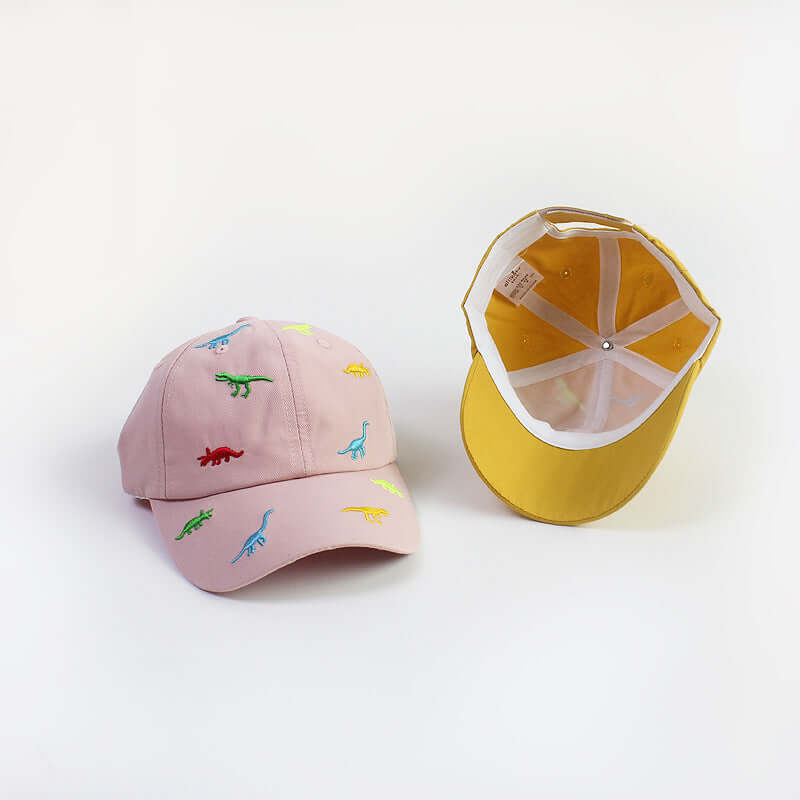 RICYGVM Dinosaur Embroidered Kids Baseball Cap featuring colorful dino designs on a pink background.