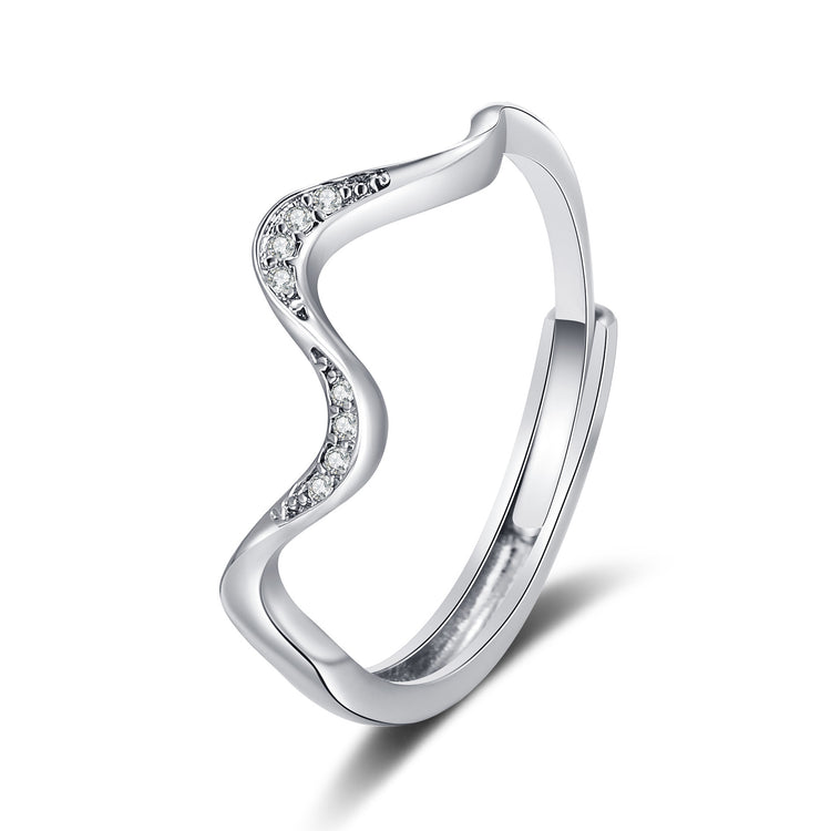 Silver ring with wavy design and small diamonds on a white background