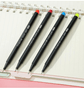 Fine Point Markers in various colors on a notebook, perfect for art drawing and detailed illustrations.