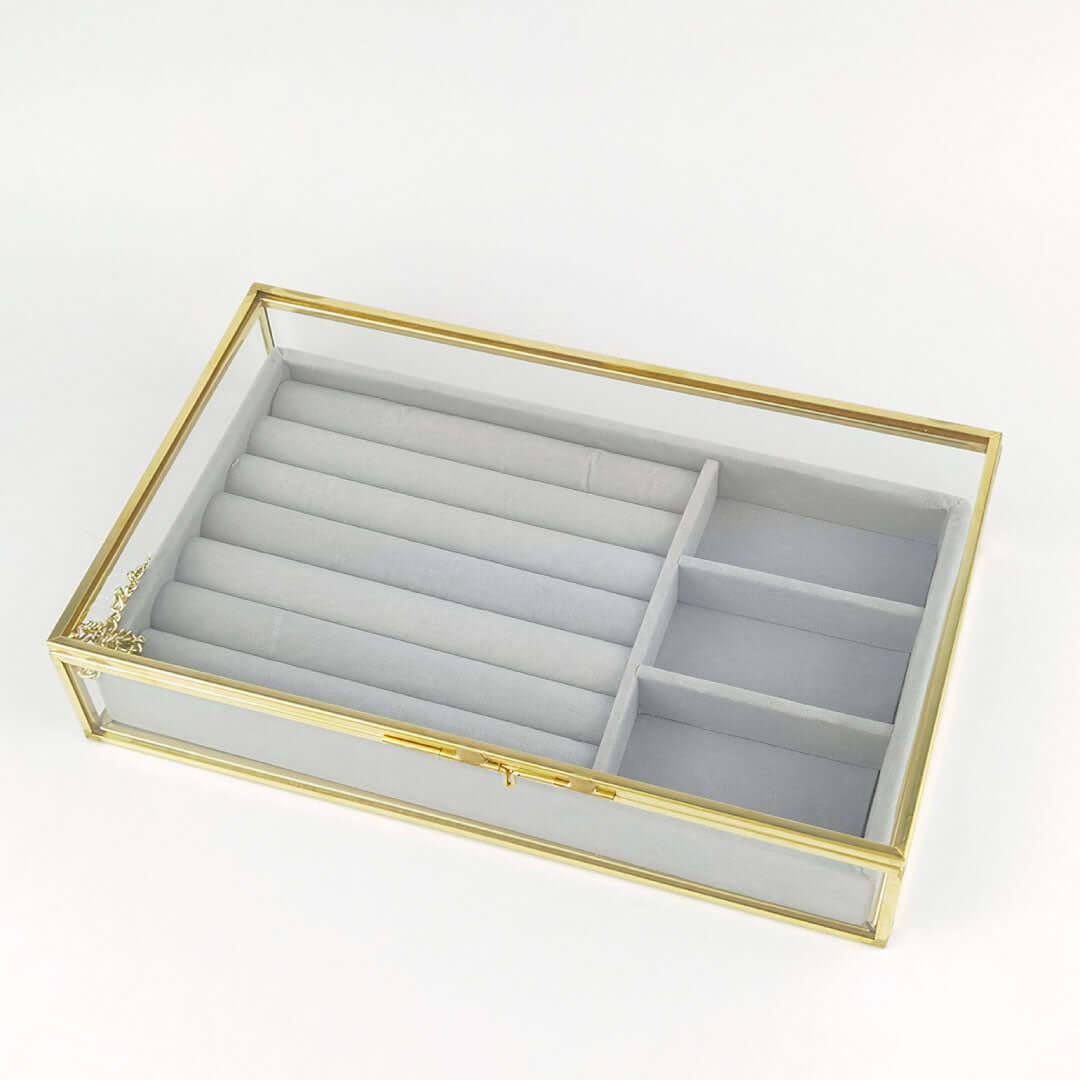 Organizing Jewelry Box with compartments for necklaces and rings, featuring a glass top and gold accents.