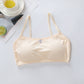 Beige bralette on a light gray surface with a cup and lime in the background