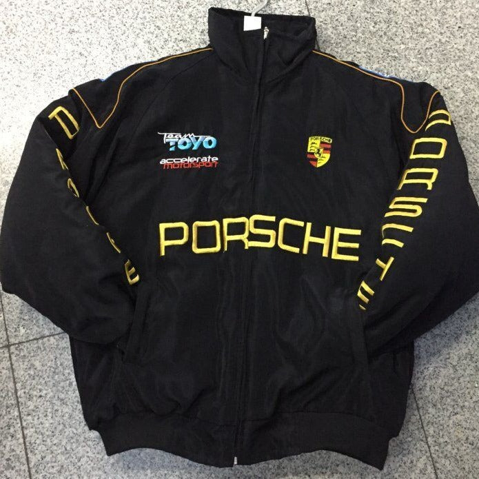 Black Porsche jacket with logos on a gray floor