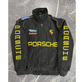 Black Porsche jacket with branding on a textured gray background