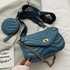 Blue handbag with gold chain and matching round pouch on a light background