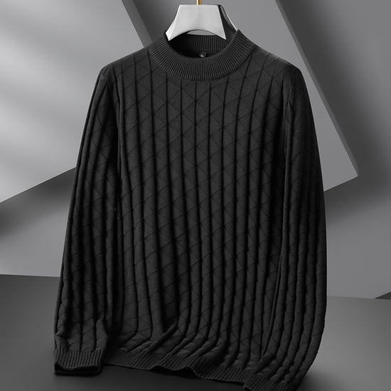 Dark gray sweater on a hanger against a neutral background