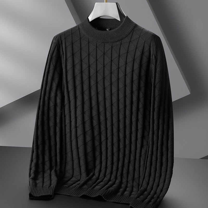 Dark gray sweater on a hanger against a neutral background