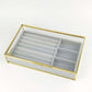 Jewelry Box Organizer with gold accents and gray compartments for stylish jewelry storage.