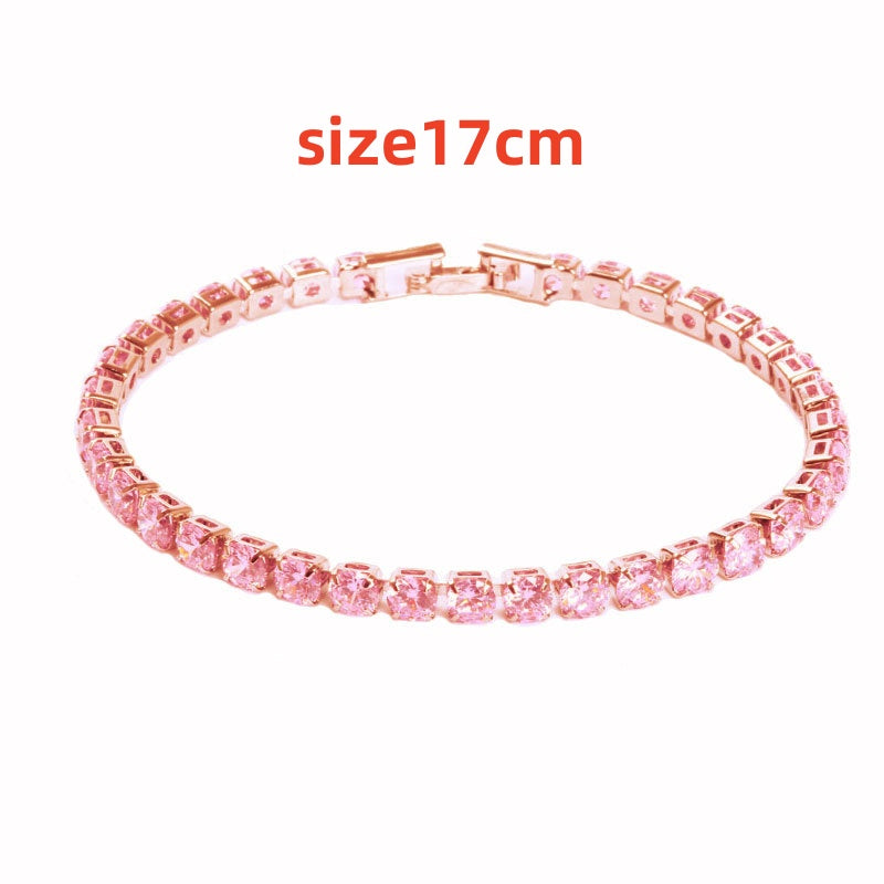 Pink bracelet with gold clasp on a white background, labeled &