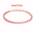 Pink bracelet with gold clasp on a white background, labeled &