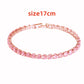 Pink bracelet with gold clasp on a white background, labeled &