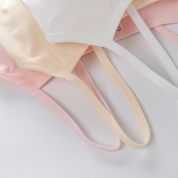 Three ribbons in pink, beige, and white on a light gray background