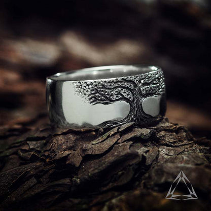 Silver tree ring on a wooden surface with a blurred background