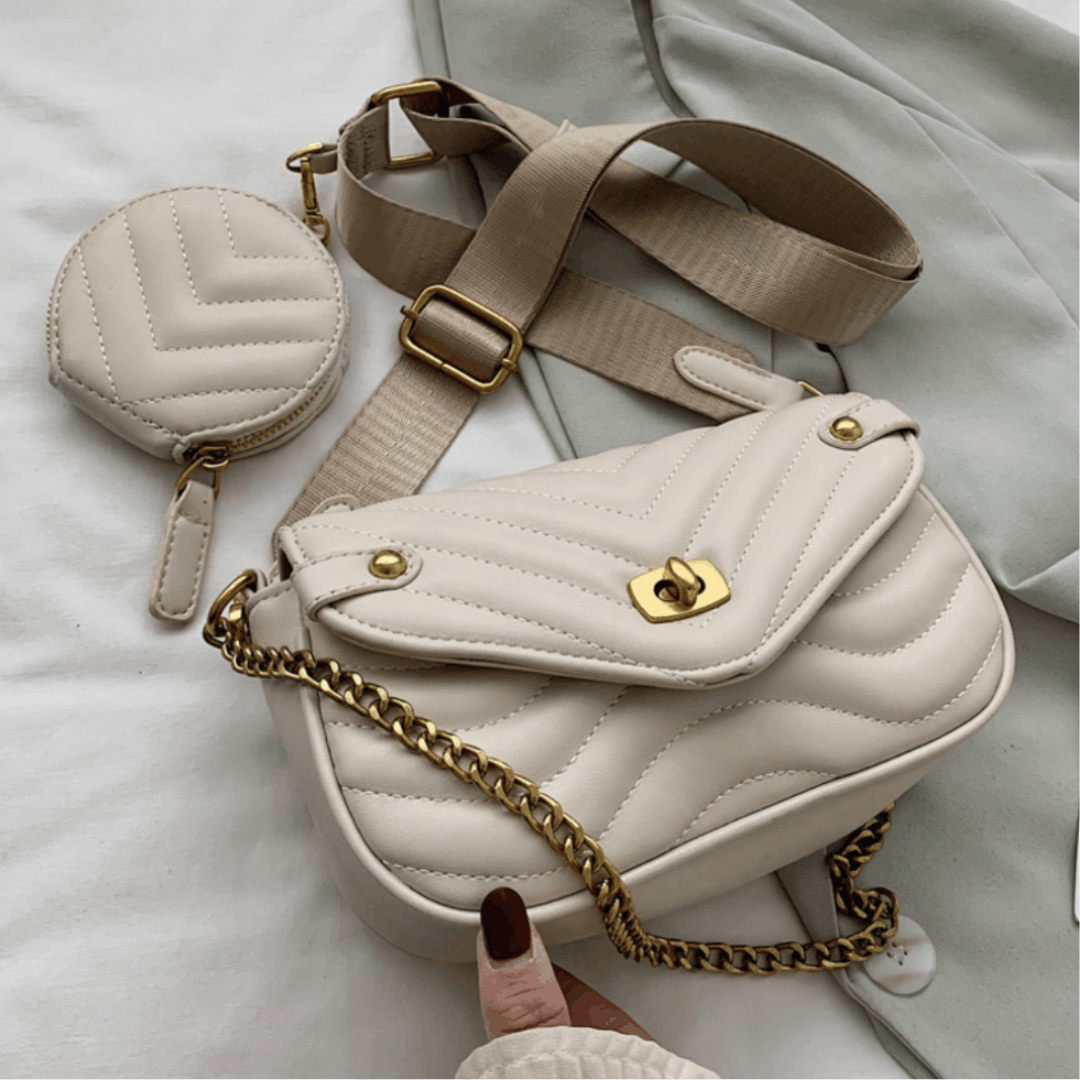White quilted handbag with gold chain and matching coin purse on a light background
