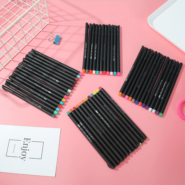 Fine Point Markers fine tip art drawing fineliner pen set arranged on a pink background for creative projects.