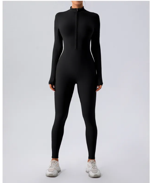 Person wearing a black full-body suit on a light gray background