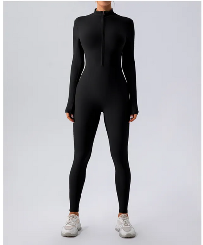 Person wearing a black full-body suit on a light gray background