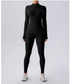 Person wearing a black full-body suit on a light gray background