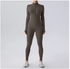 Person wearing a gray full-body suit on a light gray background