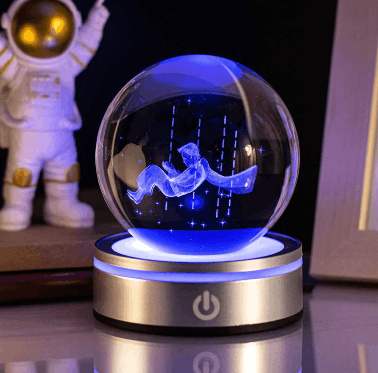 Crystal ball with 3D astronaut figure inside, illuminated by blue light, on a dark background.
