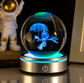 Glass ball with a blue figure inside, illuminated by a power button on a dark background