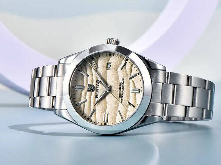 Silver watch with beige dial on a light blue background