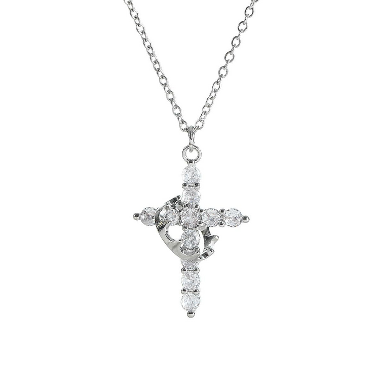 Silver cross pendant necklace with clear stones on a white background